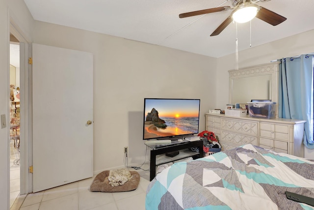 bedroom featuring ceiling fan and light tile floors