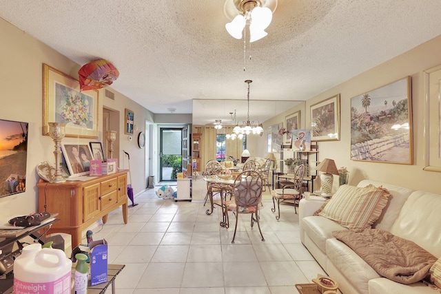 dining area with ceiling fan with notable chandelier, a textured ceiling, and light tile flooring