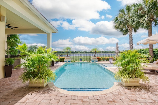 view of swimming pool with a patio and ceiling fan