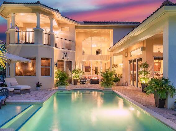 pool at dusk featuring outdoor lounge area and a patio