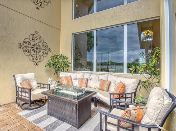 view of patio with an outdoor living space with a fire pit