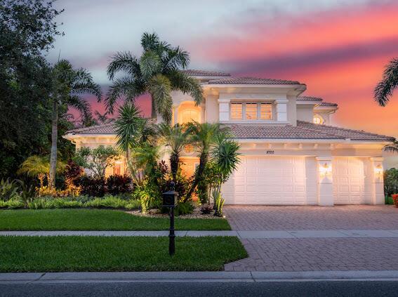 mediterranean / spanish house with a garage and a yard