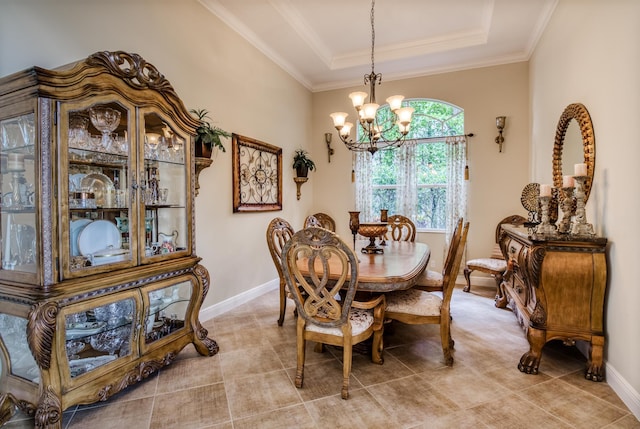 dining room featuring an inviting chandelier, ornamental molding, and a raised ceiling