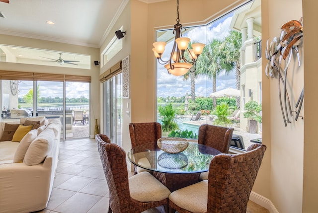 tiled dining room with ornamental molding and ceiling fan with notable chandelier