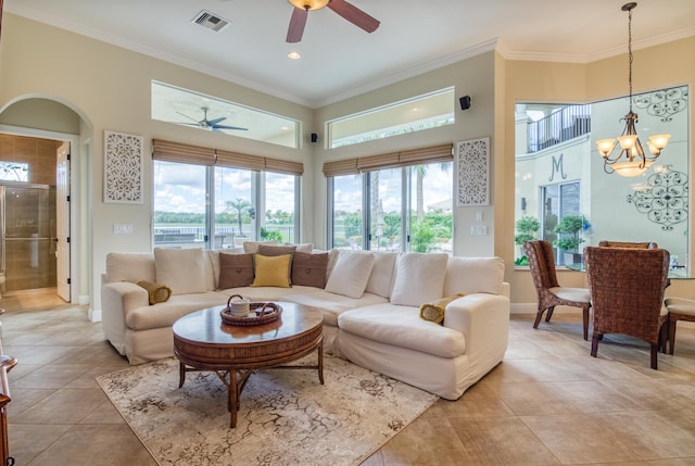 tiled living room with crown molding and ceiling fan with notable chandelier