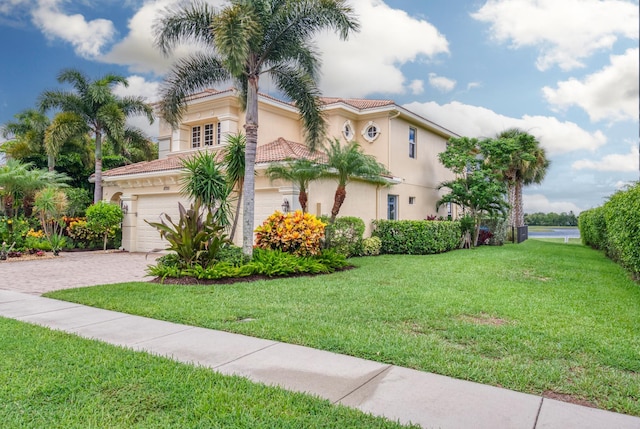 view of front facade with a garage and a front yard