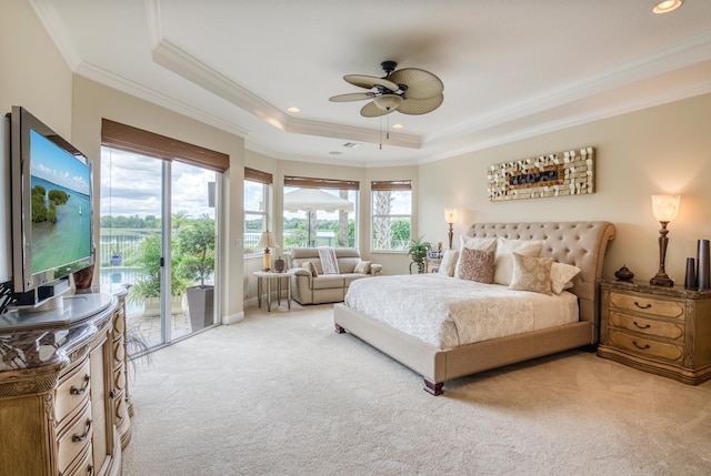 carpeted bedroom featuring a tray ceiling, access to outside, ornamental molding, and ceiling fan