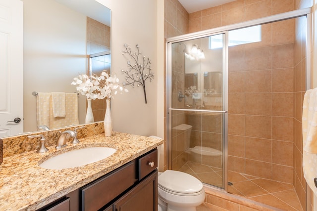 bathroom with vanity, toilet, and walk in shower