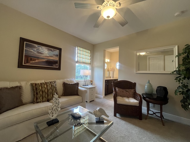 carpeted living room with ceiling fan