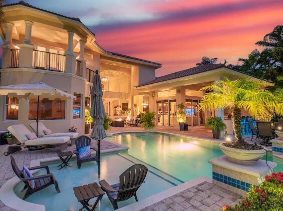 pool at dusk with a patio