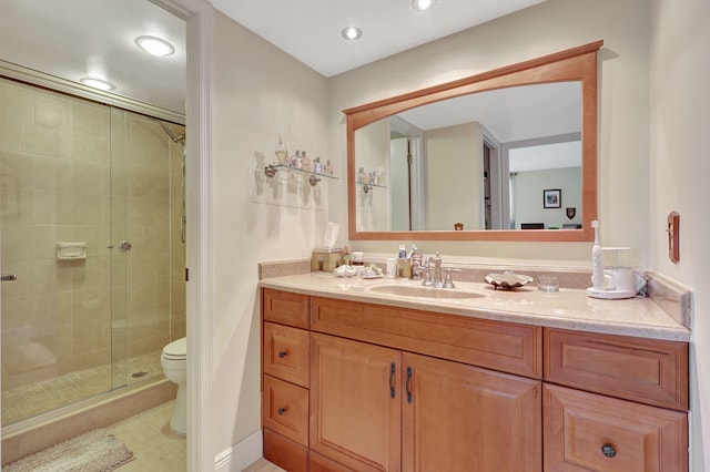 bathroom featuring vanity, toilet, tile patterned flooring, and an enclosed shower