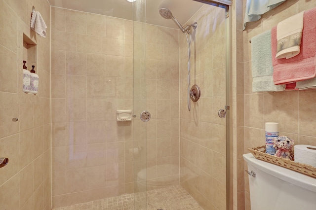 bathroom with toilet and a shower with shower door