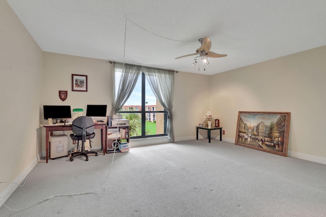 carpeted home office featuring ceiling fan