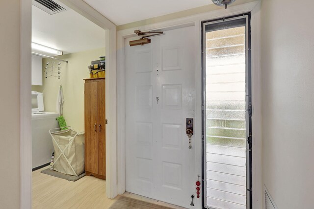 foyer featuring washer / dryer and wood-type flooring