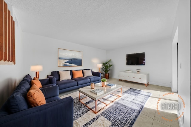 tiled living room featuring a textured ceiling