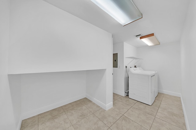 clothes washing area featuring electric panel, washing machine and dryer, and light tile patterned flooring