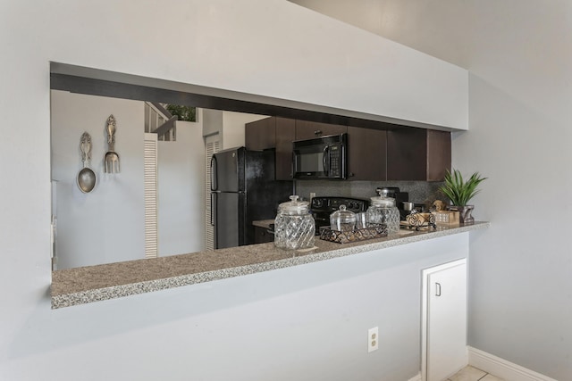 kitchen with backsplash, black appliances, dark brown cabinetry, light stone countertops, and kitchen peninsula