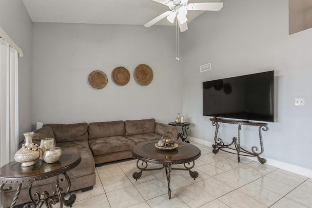 living room with ceiling fan, light tile patterned floors, and high vaulted ceiling