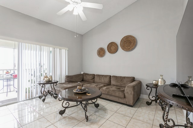 living room featuring ceiling fan, lofted ceiling, and light tile patterned floors