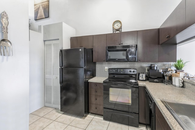 kitchen featuring sink, tasteful backsplash, dark brown cabinets, light tile patterned floors, and black appliances