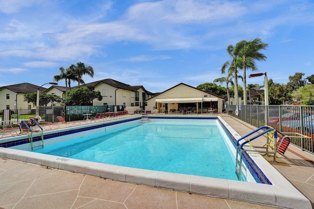 pool featuring a patio area and fence