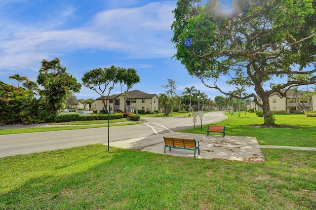 view of home's community featuring a residential view and a yard