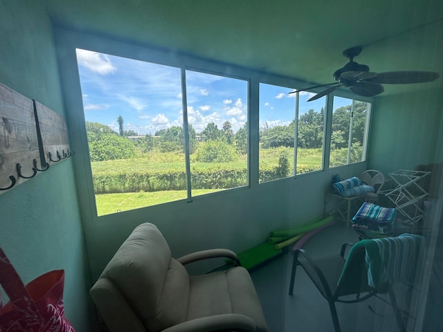 sunroom / solarium with ceiling fan and a healthy amount of sunlight