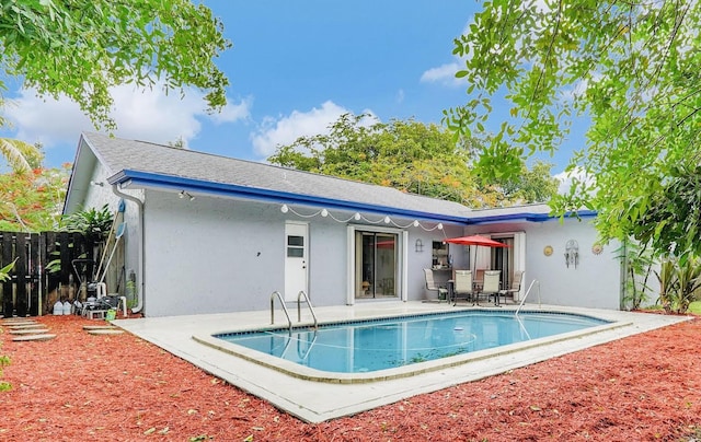 rear view of property featuring a patio area