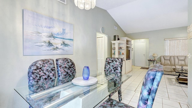 tiled dining area featuring an inviting chandelier and vaulted ceiling