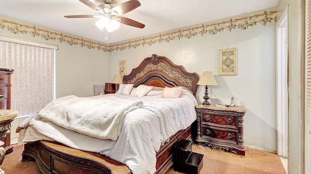 carpeted bedroom featuring ceiling fan and a textured ceiling