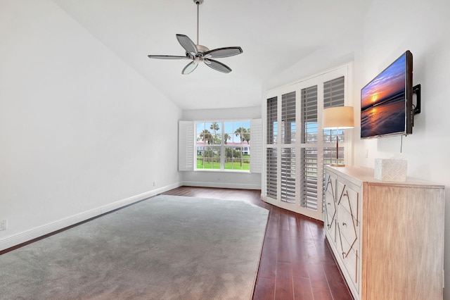 unfurnished living room with ceiling fan, dark hardwood / wood-style floors, and lofted ceiling