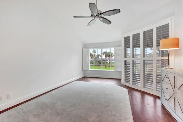 unfurnished bedroom featuring dark wood-type flooring, vaulted ceiling, and ceiling fan