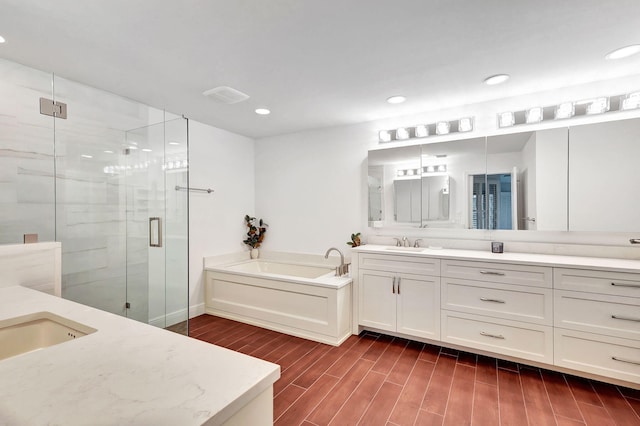 bathroom with separate shower and tub and vanity