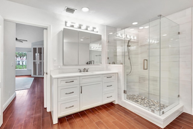 bathroom with walk in shower and vanity