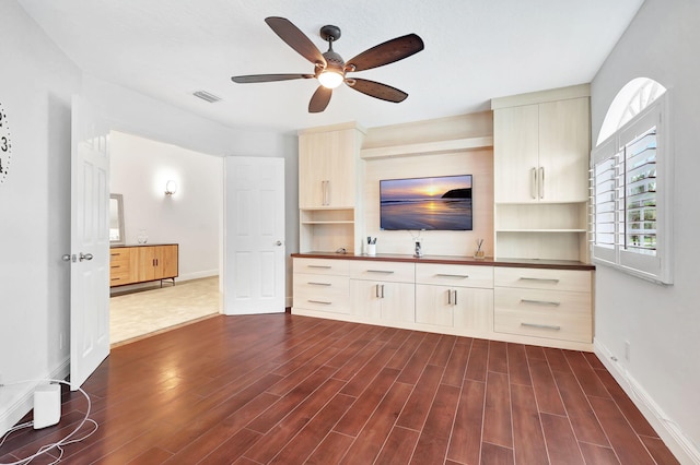 unfurnished living room featuring ceiling fan