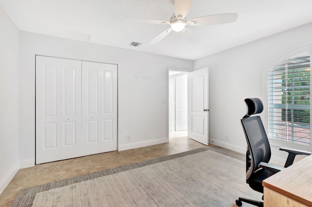 tiled office space featuring ceiling fan