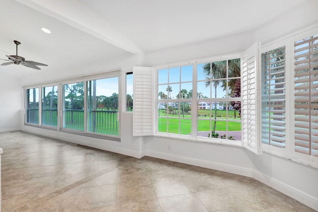 unfurnished sunroom with ceiling fan and vaulted ceiling