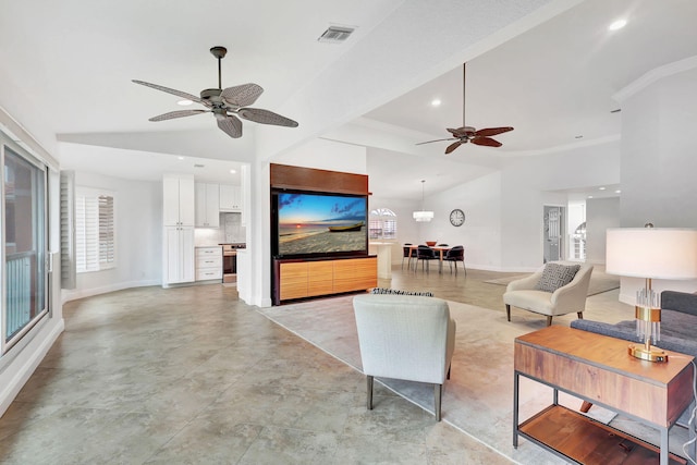 living room with ceiling fan and vaulted ceiling