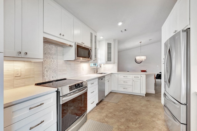 kitchen featuring pendant lighting, white cabinetry, and stainless steel appliances