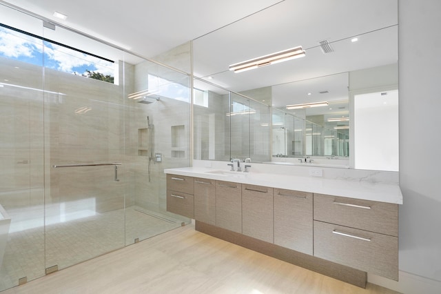 bathroom featuring vanity and a shower with shower door