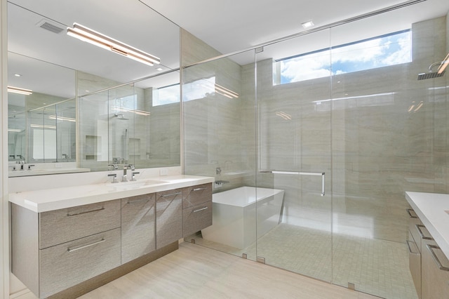 bathroom featuring vanity and a shower with shower door