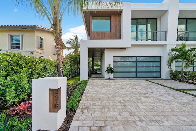 modern home featuring a balcony and a garage