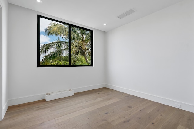 unfurnished room with light wood-type flooring