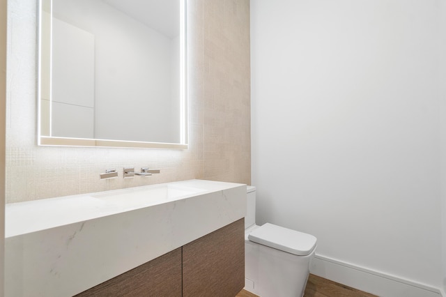 bathroom featuring toilet and vanity