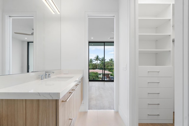 bathroom with vanity, floor to ceiling windows, and ceiling fan