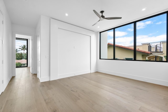 spare room with light hardwood / wood-style floors and ceiling fan