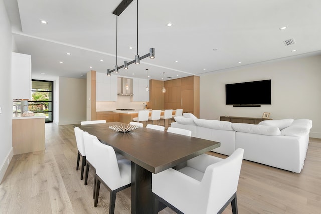 dining area featuring light wood-type flooring