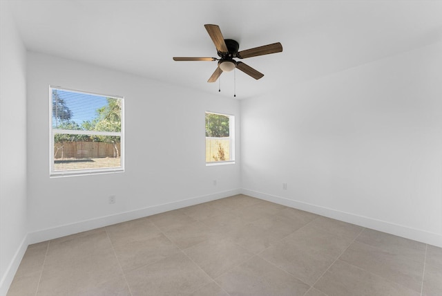 empty room featuring light tile patterned floors and ceiling fan