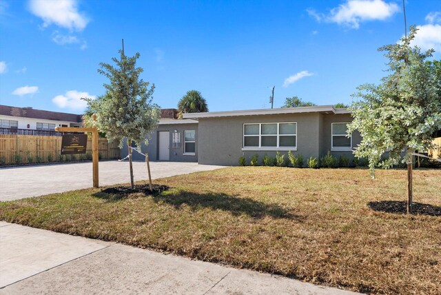 ranch-style house with a front lawn