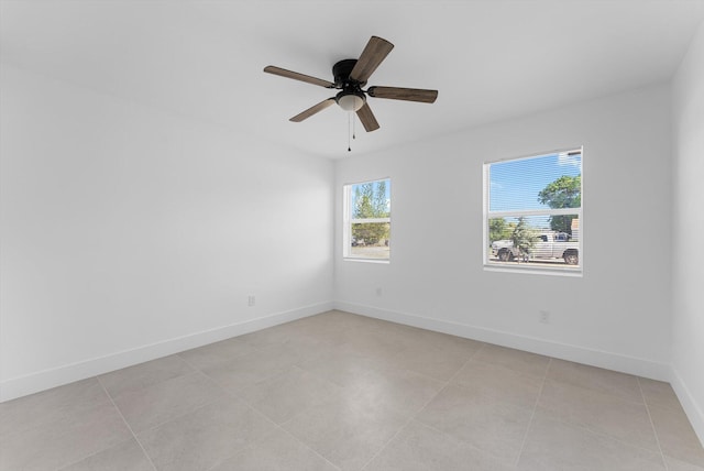 tiled empty room with ceiling fan